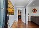 Inviting entryway with hardwood floors, bench and stylish artwork leads into a bright, welcoming home at 2984 Bayard St, East Point, GA 30344