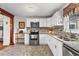 Modern kitchen featuring white cabinets, stainless steel appliances, and stylish mosaic backsplash at 2984 Bayard St, East Point, GA 30344