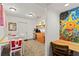 Charming dining area featuring a table, chairs, bright mosaic wall decor, and kitchen appliances at 2984 Bayard St, East Point, GA 30344