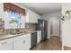 Bright kitchen with white cabinetry, stainless steel appliances, and elegant granite countertops at 2984 Bayard St, East Point, GA 30344