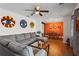 Inviting living room showcases colorful wall art, a comfortable gray sofa, and an adjacent dining area at 2984 Bayard St, East Point, GA 30344