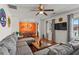 Cozy living room featuring a plush gray sectional sofa, decorative curtains, and unique wall decor at 2984 Bayard St, East Point, GA 30344