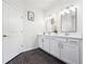 Bright bathroom with double sinks, quartz countertops, modern fixtures, and Herringbone tile floors at 2815 Paddle Point Ln, Cumming, GA 30041