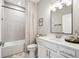 Well-lit bathroom featuring a shower and tub, a modern vanity with a white countertop, and tile flooring at 2815 Paddle Point Ln, Cumming, GA 30041