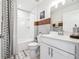 Well-lit bathroom with a shower-tub combo, white vanity, and decorative mirror at 2815 Paddle Point Ln, Cumming, GA 30041