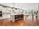 Open-concept kitchen featuring an island with bar seating, stainless steel appliances, and hardwood floors at 2815 Paddle Point Ln, Cumming, GA 30041