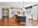 Bright, open kitchen features a center island with bar stools, white cabinetry, and stainless steel appliances at 2815 Paddle Point Ln, Cumming, GA 30041
