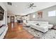 Spacious living room with hardwood floors, an open concept to the kitchen, and a comfortable white sectional sofa at 2815 Paddle Point Ln, Cumming, GA 30041