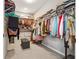 A spacious walk-in closet featuring carpeted floor and ample space for clothing and storage at 2815 Paddle Point Ln, Cumming, GA 30041