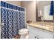 Well-lit bathroom with granite countertops and a stylish shower curtain at 90 Belleview Rdg, Sharpsburg, GA 30277