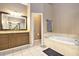 Well-appointed bathroom with soaking tub, vanity, and tiled floors at 90 Belleview Rdg, Sharpsburg, GA 30277