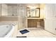Well-lit bathroom with soaking tub, walk-in shower, and vanity at 90 Belleview Rdg, Sharpsburg, GA 30277