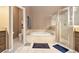 Bright bathroom boasts a soaking tub and glass-enclosed shower at 90 Belleview Rdg, Sharpsburg, GA 30277