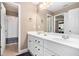 Clean bathroom featuring a double vanity and large mirror in neutral colors at 90 Belleview Rdg, Sharpsburg, GA 30277