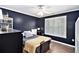 Modern bedroom featuring a dark color scheme, large window, and natural light at 90 Belleview Rdg, Sharpsburg, GA 30277