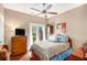 Comfortable bedroom with a ceiling fan and a door to the outside at 90 Belleview Rdg, Sharpsburg, GA 30277