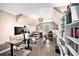 Versatile bonus room with multiple desks, chandelier, and natural lighting at 90 Belleview Rdg, Sharpsburg, GA 30277