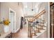 Inviting foyer with staircase, wood floors, high ceilings, and view into the living room creates a seamless transition at 90 Belleview Rdg, Sharpsburg, GA 30277