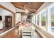 Comfortable living room features a stone fireplace, wood-paneled ceiling, and view to the backyard at 90 Belleview Rdg, Sharpsburg, GA 30277