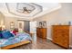 Spacious main bedroom featuring a tray ceiling and wood floors at 90 Belleview Rdg, Sharpsburg, GA 30277
