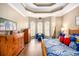 Serene main bedroom features wood floors, a tray ceiling, and abundant natural light at 90 Belleview Rdg, Sharpsburg, GA 30277
