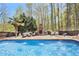 Relaxing pool with in-pool fountains, fireplace and plenty of outdoor furniture for easy entertaining at 90 Belleview Rdg, Sharpsburg, GA 30277