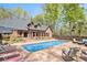 Beautiful backyard with a private swimming pool, spa, and lush landscaping at 90 Belleview Rdg, Sharpsburg, GA 30277