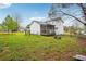 Exterior view of home with large yard, featuring a screened porch at 10386 Wisteria Ln, Jonesboro, GA 30238