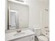 Bathroom vanity featuring a white counter, sink, and mirror at 10386 Wisteria Ln, Jonesboro, GA 30238