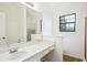 Bathroom featuring a white vanity and shower-tub combo at 10386 Wisteria Ln, Jonesboro, GA 30238
