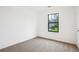 Cozy bedroom with neutral carpet and a window providing natural light at 10386 Wisteria Ln, Jonesboro, GA 30238