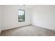 Bright bedroom features carpet, a window, and neutral tones at 10386 Wisteria Ln, Jonesboro, GA 30238