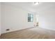 Bright bedroom features carpet, a window, and neutral tones at 10386 Wisteria Ln, Jonesboro, GA 30238