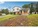 Charming home with stone facade, white siding, and inviting front porch, situated on a partially wooded lot at 10386 Wisteria Ln, Jonesboro, GA 30238