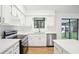 Modern kitchen featuring sleek countertops, stainless steel appliances, and ample cabinet space for storage at 10386 Wisteria Ln, Jonesboro, GA 30238