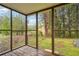 Enclosed screened-in porch featuring wood flooring and an airy atmosphere with backyard views at 10386 Wisteria Ln, Jonesboro, GA 30238