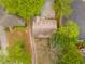 Aerial view of a home with a gravel parking pad and a view of surrounding foliage at 1387 Church St, Decatur, GA 30030
