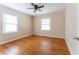 Bedroom featuring two windows, hardwood floors, and light beige-colored walls at 1387 Church St, Decatur, GA 30030