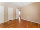 Bedroom with hardwood flooring, two white doors, beige walls, and an entryway at 1387 Church St, Decatur, GA 30030