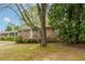 A cozy brick home with well-kept landscaping, surrounded by mature trees, offering a serene setting at 1387 Church St, Decatur, GA 30030