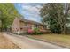 Charming one story brick home with a well-maintained lawn and colorful flower bushes at 1387 Church St, Decatur, GA 30030