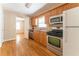 Well-lit kitchen with stainless steel appliances, wood cabinets, and hardwood flooring at 1387 Church St, Decatur, GA 30030