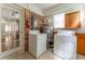 Laundry room with washer, dryer, and brick accent wall at 1387 Church St, Decatur, GA 30030