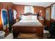 Relaxing bedroom showcases wood-paneled walls, complemented by classic wood furniture and soft, natural light at 1774 Pennington Se Pl, Atlanta, GA 30316