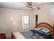 Distressed room, featuring a ceiling fan, vintage window, and a full-sized bed, awaits a refreshing update at 1774 Pennington Se Pl, Atlanta, GA 30316