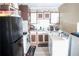 Features standard appliances, brown-and-white cabinetry, and vintage décor for a cozy, traditional cooking space at 1774 Pennington Se Pl, Atlanta, GA 30316