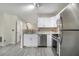 The kitchen features stainless steel appliances, white cabinets, and updated countertops at 206 Oak Grove Way, Acworth, GA 30102