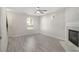Open living room features grey wood-look flooring and a classic fireplace at 206 Oak Grove Way, Acworth, GA 30102
