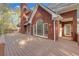 Brick home featuring large arched windows, wood deck, and landscaped backyard at 240 River Cove Mdws, Social Circle, GA 30025