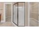 Beautiful tile and glass enclosed shower with chrome hardware and fixtures at 240 River Cove Mdws, Social Circle, GA 30025